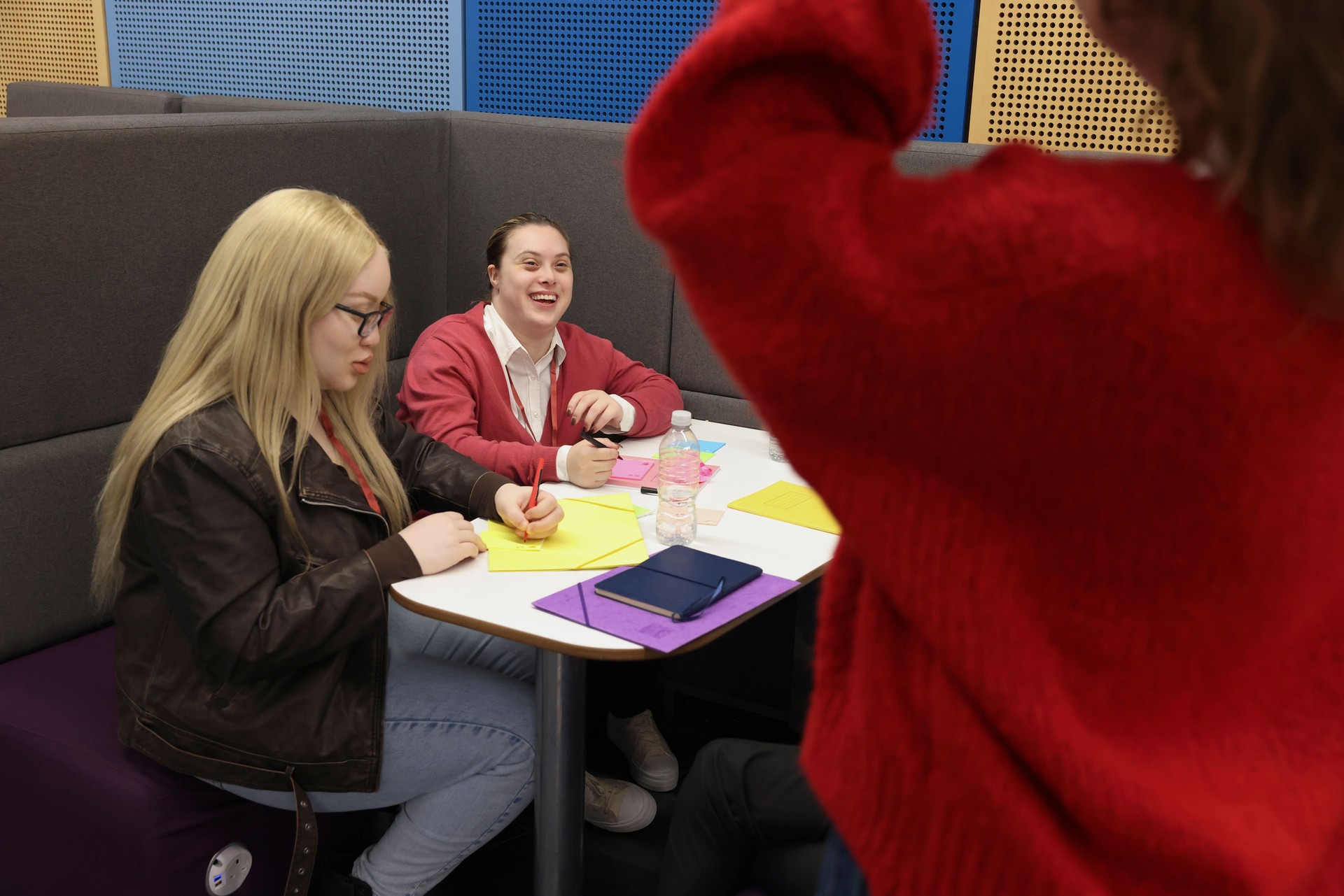 Disabled people writing at table