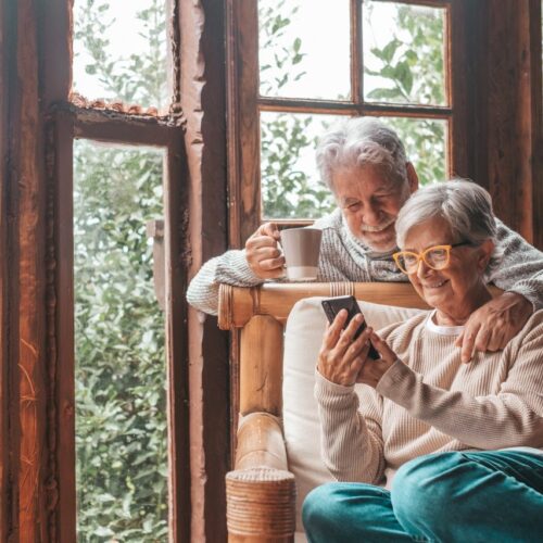 couple-of-two-old-and-mature-people-at-home-using-phone-together-in-sofa-senior-use-smartphone.jpg