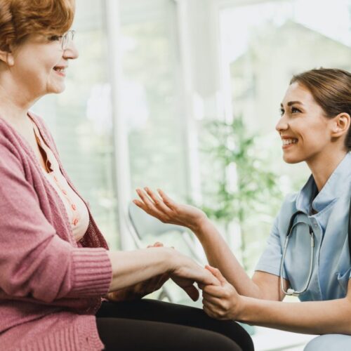 senior-woman-talking-to-caring-nurse-at-waiting-room.jpg